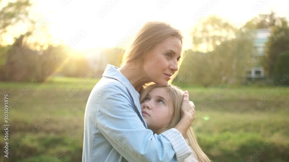 Lovely couple, mom and daughter are hugging in the autumn city park. Maternal love, teenage daughter Lovely couple, mom and daughter are hugging in the autumn city park. Maternal love, teenage daughter