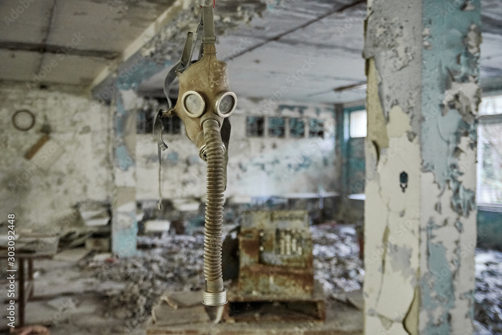 Gas masks on the floor with an old television in an abandoned middle school in Pripyat