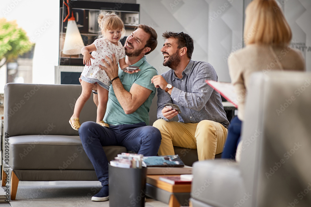 gay couple in shopping. couple enjoying in shopping with child girl gay couple in shopping. couple enjoying in shopping with child girl