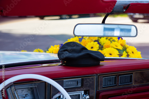 Antique white convertible decorated with yellow flowers.