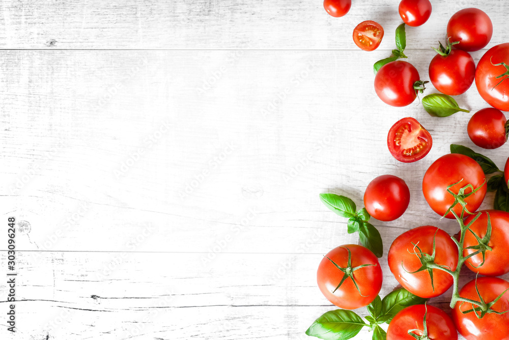Fresh ripe tomatoes on white background top view. Tomato red vegetable concept, copy space for text with basil leaves. - obrazy, fototapety, plakaty 