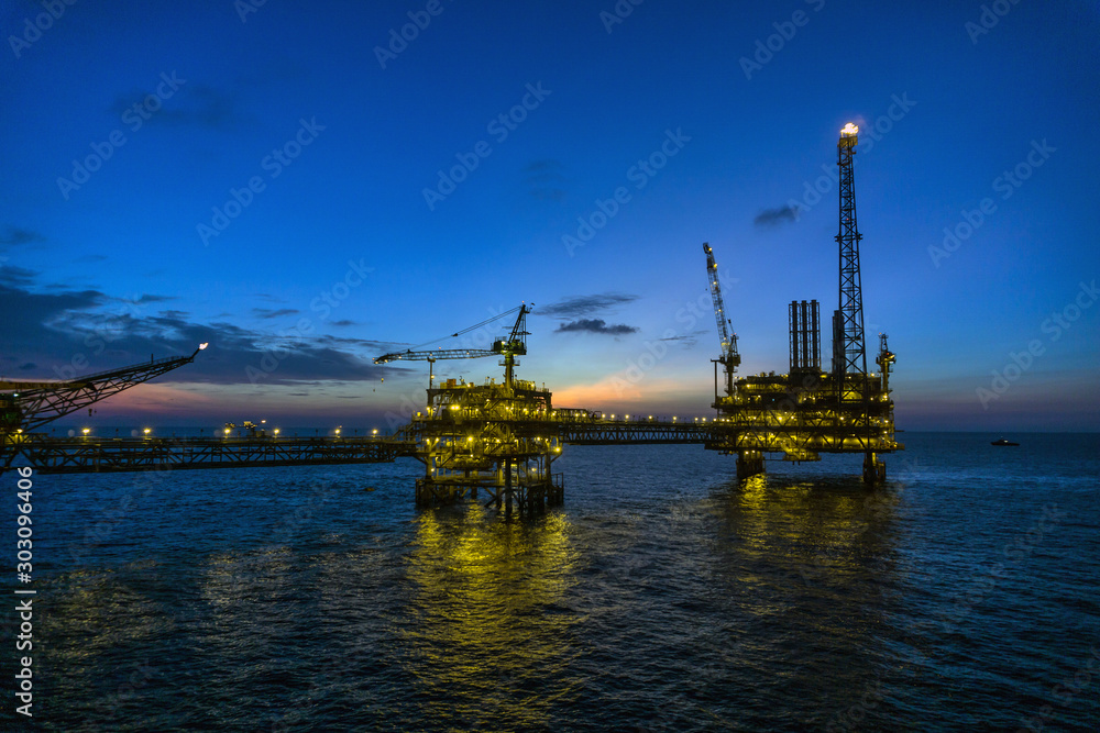 Oil production platform during sunset or blue hour