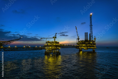 Oil production platform during sunset or blue hour