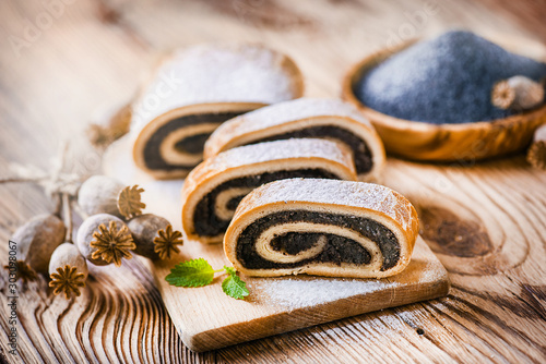 Fotografie Fresh beautiful poppy roll cakes or strudel on old table