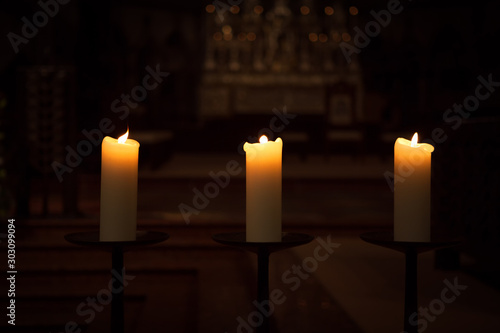 three candles on the black background