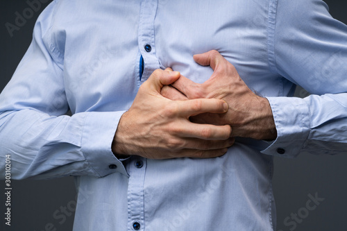 Tableau sur toile Man Wearing Blue Shirt Suffering From Heart Attack