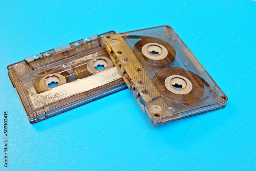 Transparent audio cassettes located on a blue background Transparent audio cassettes located on a blue background