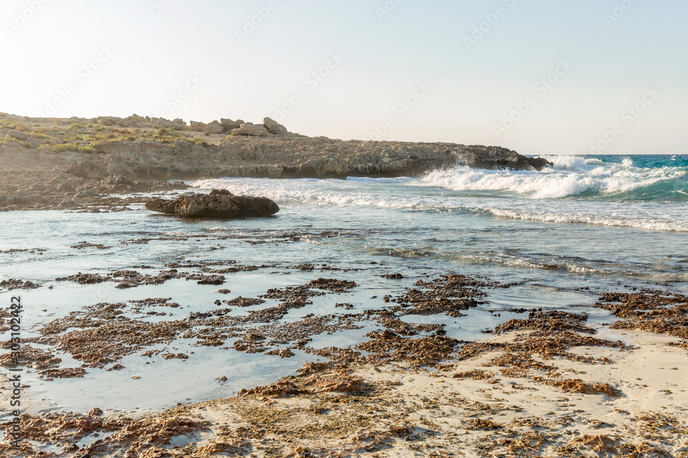Rocky shore of the turquoise sea on a sunny day. Beautiful landscape. Background. Space for text. Rocky shore of the turquoise sea on a sunny day. Beautiful landscape. Background. Space for text.