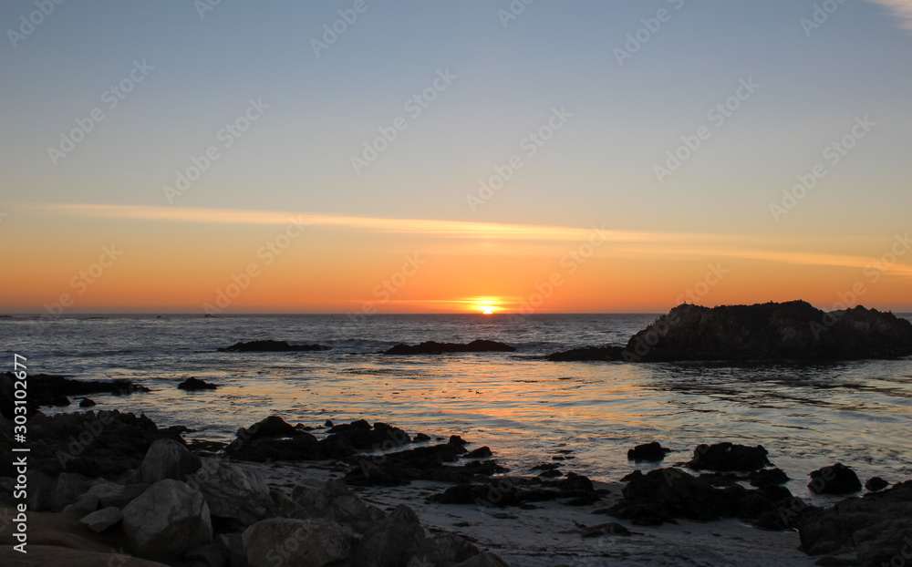 Beautiful view of sunset from Pebble Beach in Monterey County, California. Pebble beach is part of 17-Mile Drive which is a scenic road through Pacific Grove.