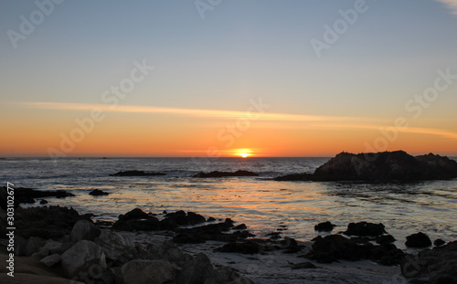 Beautiful view of sunset from Pebble Beach in Monterey County, California. Pebble beach is part of 17-Mile Drive which is a scenic road through Pacific Grove. © Manivannan T