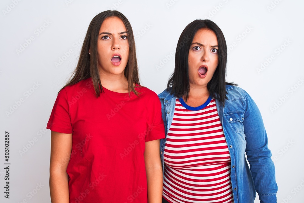 Young beautiful women wearing casual clothes standing over isolated white background In shock face, looking skeptical and sarcastic, surprised with open mouth