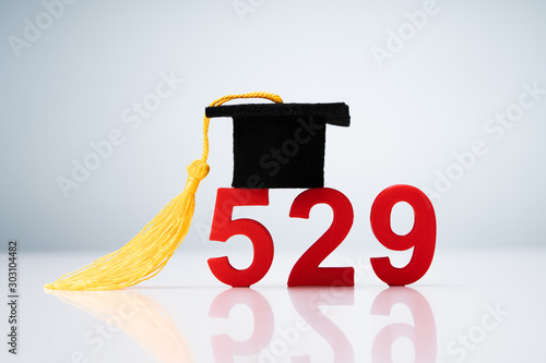 529 Number Showing With Miniature Of Graduation Hat Over Desk photo