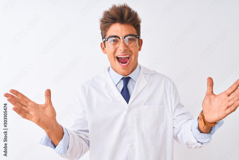 Young handsome sciencist man wearing glasses and coat over isolated white background celebrating crazy and amazed for success with arms raised and open eyes screaming excited. Winner concept Young handsome sciencist man wearing glasses and coat over isolated white background celebrating crazy and amazed for success with arms raised and open eyes screaming excited. Winner concept