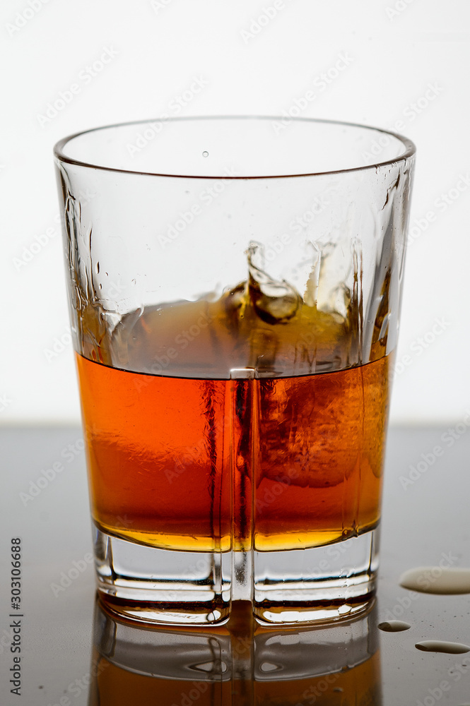 splashing whiskey in a glass on the background1