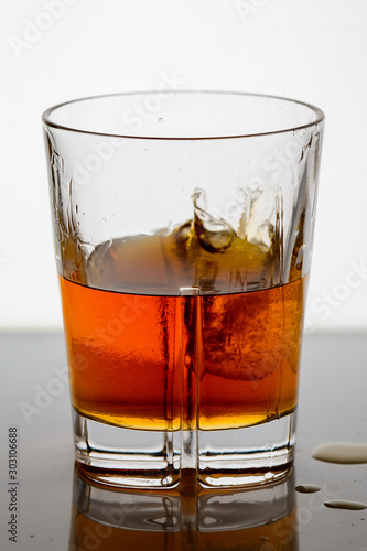 splashing whiskey in a glass on the background1