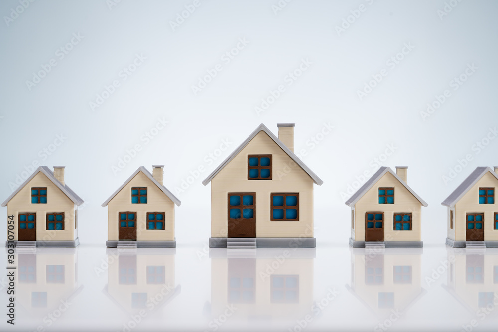 Small House Models Arranged In Row Over Table Small House Models Arranged In Row Over Table