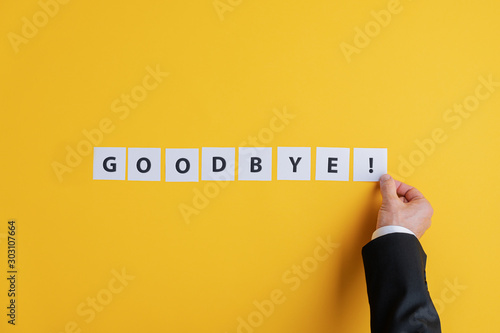 Businessman making a goodbye sign photo