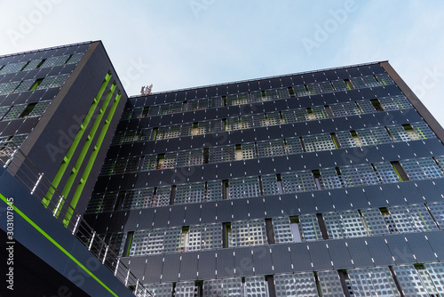 The appearance of new high-rise buildings made of glass and concrete on a blue sky background	 photo