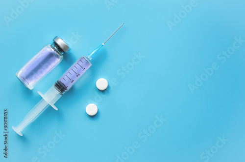 Syringe and vaccine. Medical therapy concept. Cold and flu.