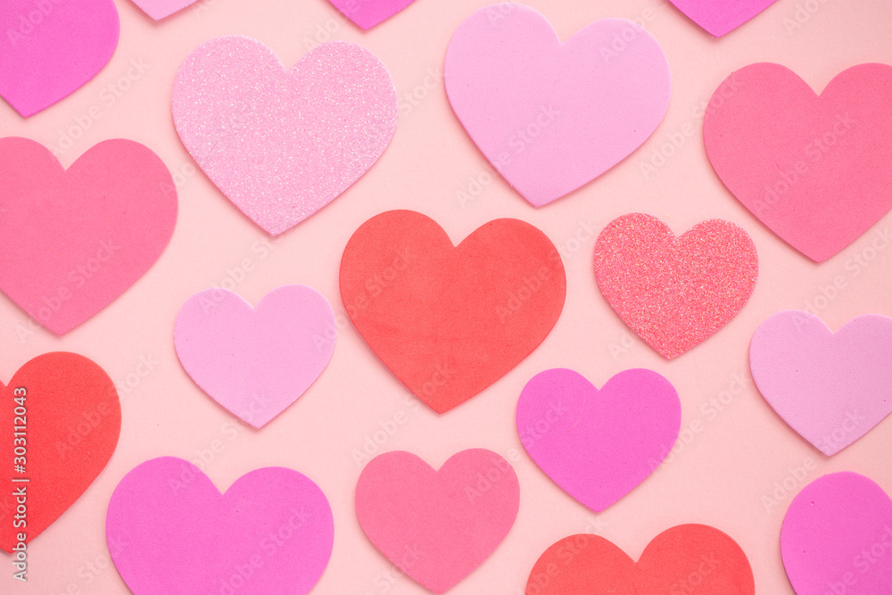 A variety of red and pink Love hearts on pink background Flat lay with copy space in a Valentine or Romance concept A variety of red and pink Love hearts on pink background Flat lay with copy space in a Valentine or Romance concept