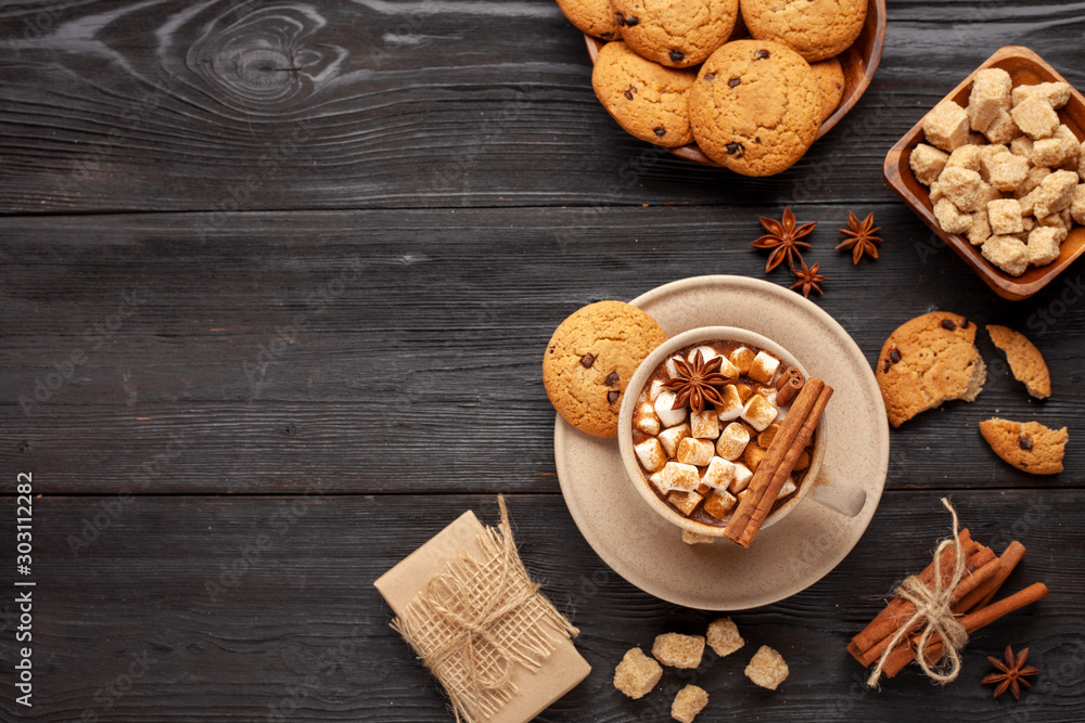 Fototapeta premium Christmas drink like cocoa with marshmallows and cookies on black background as a christmas card with copyspace for text