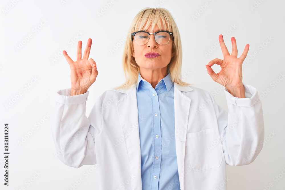 Middle age scientist woman wearing glasses standing over isolated white background relax and smiling with eyes closed doing meditation gesture with fingers. Yoga concept. Middle age scientist woman wearing glasses standing over isolated white background relax and smiling with eyes closed doing meditation gesture with fingers. Yoga concept.