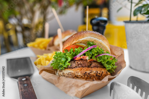 Delicious burger with potato fries chips
