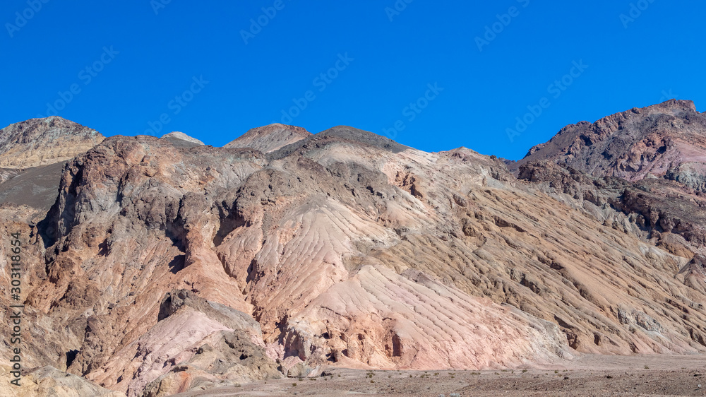 Interesting rock formations on Artist's drive in Death Valley National Park in California. Clear blue sky background Interesting rock formations on Artist's drive in Death Valley National Park in California. Clear blue sky background