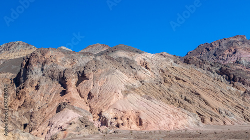 Interesting rock formations on Artist's drive in Death Valley National Park in California. Clear blue sky background