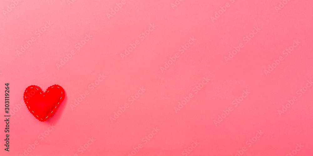 Valentine's day heart shaped pillow on a pink paper background