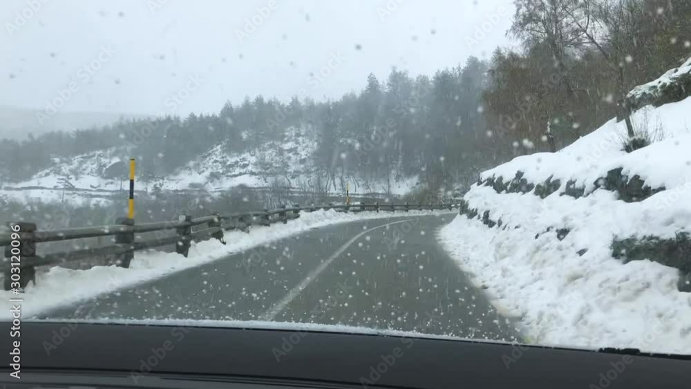 Scenic View from driver Seat of Road With Snow Covered Landscape While Snowing In Winter Season - Serra da Estrela, Portugal, Europe Scenic View from driver Seat of Road With Snow Covered Landscape While Snowing In Winter Season - Serra da Estrela, Portugal, Europe