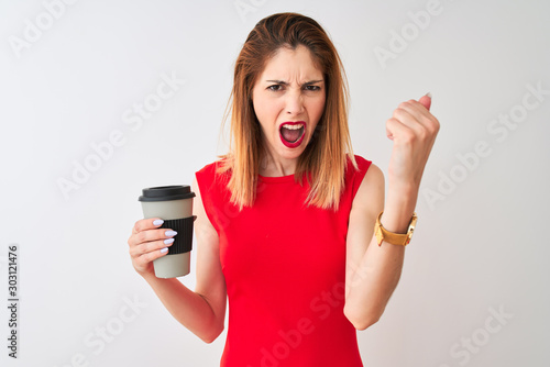 Young beautiful redhead woman drinking take away coffee over isolated white background annoyed and frustrated shouting with anger, crazy and yelling with raised hand, anger concept