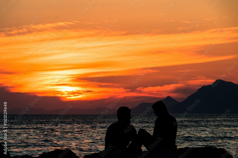 Sunset and silhouettes of lovers