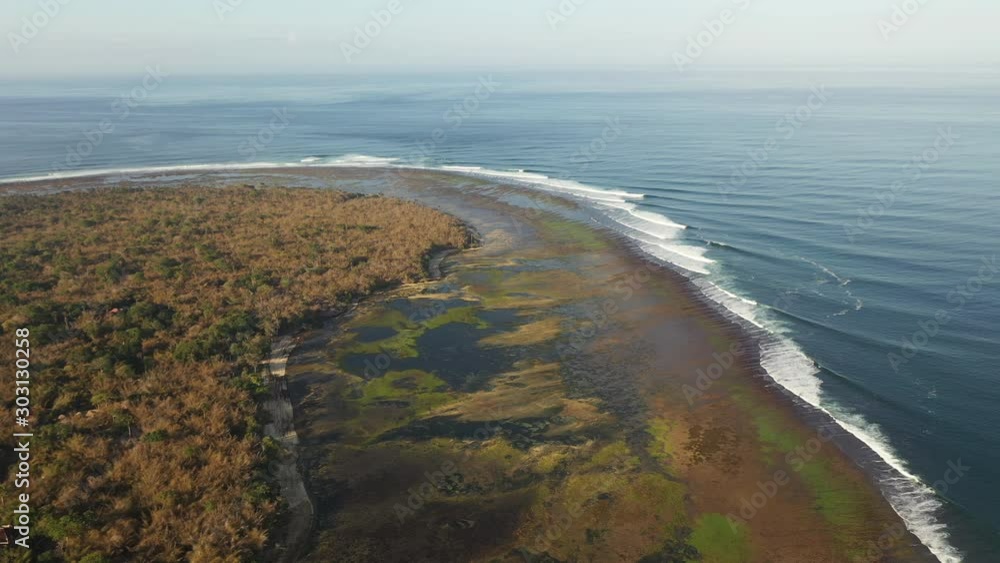 Aerial view of pint end Telaga Waja where marshes meet the ocean, Bali Indonesia, Flyover approach Aerial view of pint end Telaga Waja where marshes meet the ocean, Bali Indonesia, Flyover approach