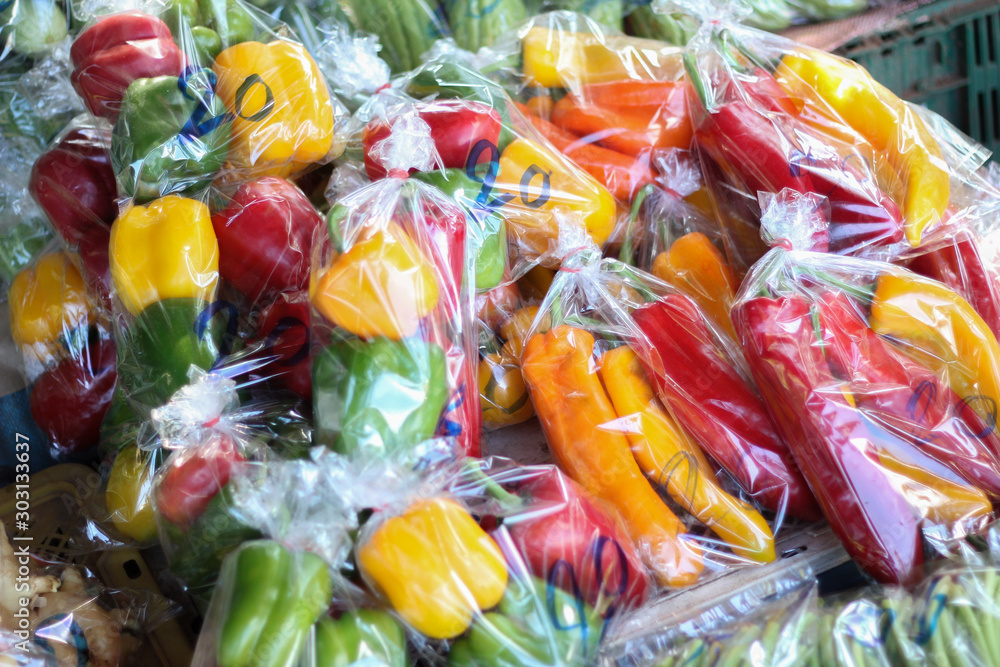 Vegetables, bell​ pepper or paprika in a plastic bag​ at​ Hill​ tribe​ local​ market​ in​ Chiangdao, Chiangmai, Thailand.​ Save​ the​ world​ concept.