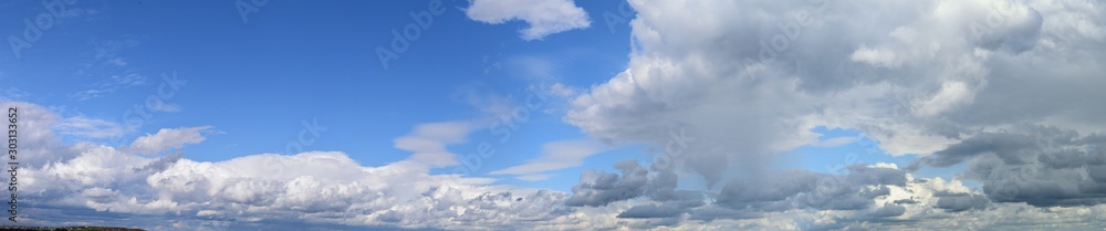 Big summer clouds. Atmospheric phenomenon - the vapor state of water. Panoramic photo Big summer clouds. Atmospheric phenomenon - the vapor state of water. Panoramic photo
