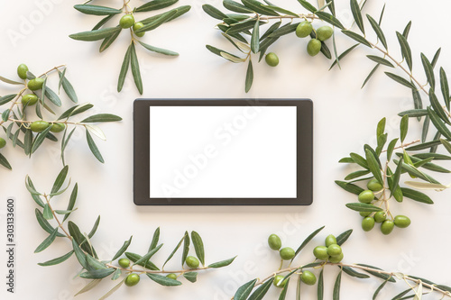 Frame with branches of an olive tree and olive fruits.