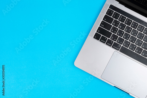 Gray laptop on a blue background.