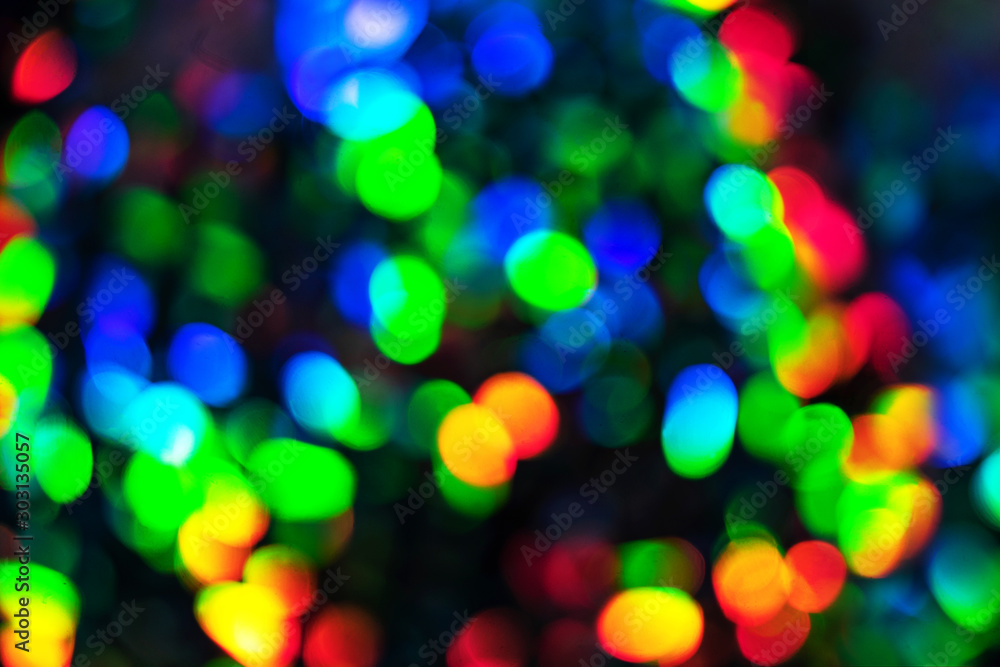 Blurred defocused multi color lights as Christmas decorations background.