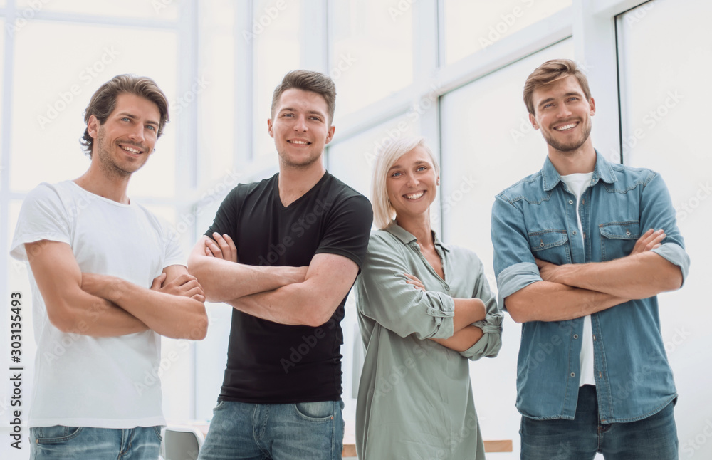 group of successful young people standing in the office group of successful young people standing in the office