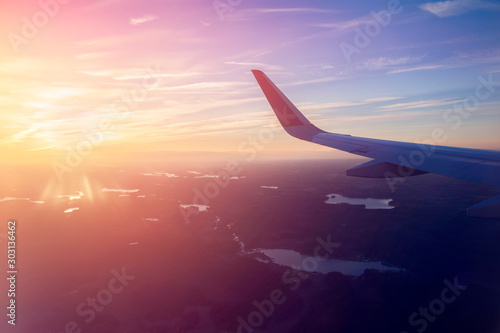 Silhouette of an airplane wing in clouds. 