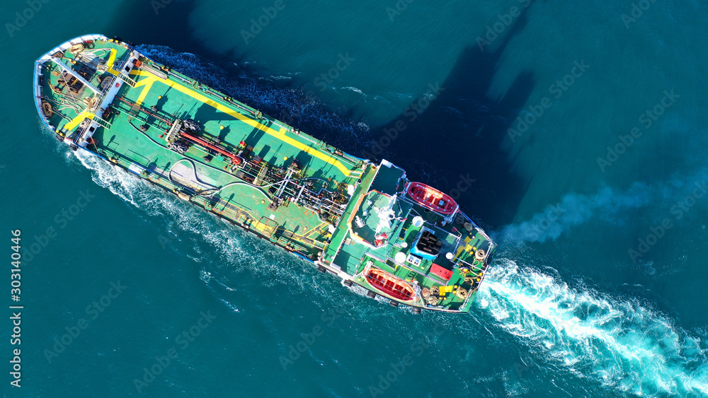 Aerial top view photo of industrial gas and petrol tanker cruising in Mediterranean bay