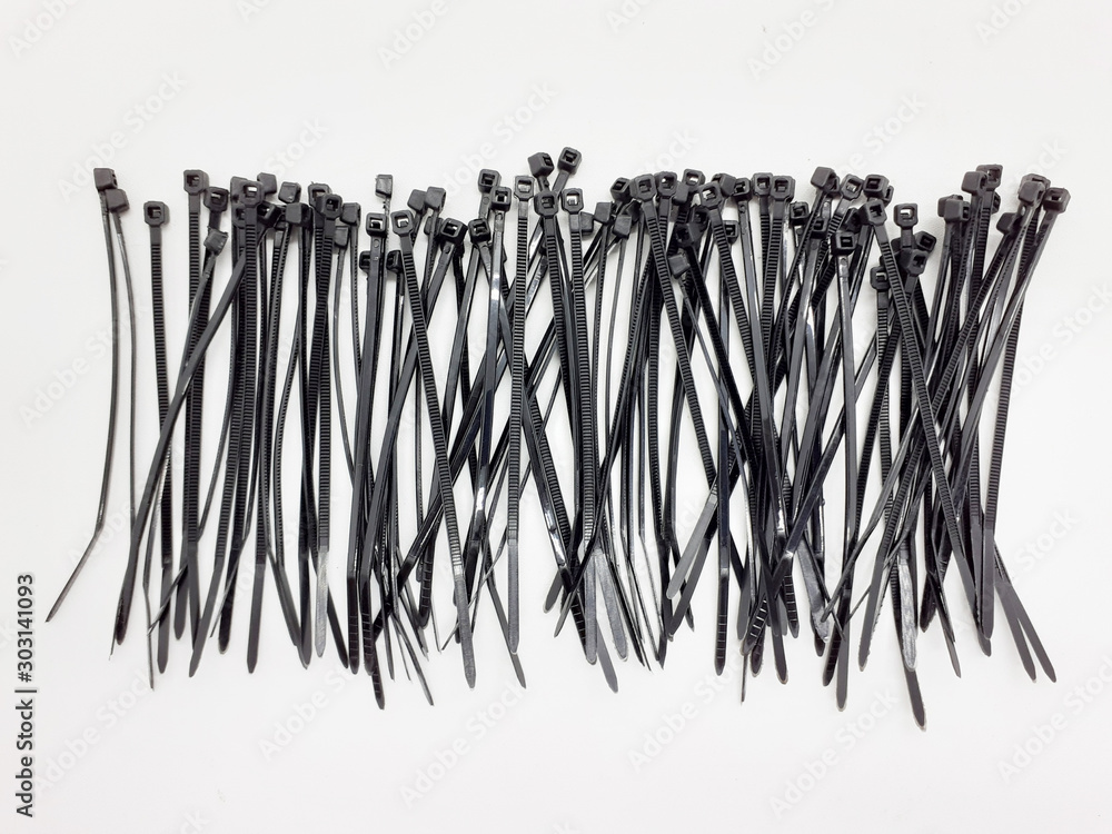 Plastic Black Ties Wire Cable for Effectively Fasten Mechanical Industrial Computer Electronic used in White Isolated Background Plastic Black Ties Wire Cable for Effectively Fasten Mechanical Industrial Computer Electronic used in White Isolated Background