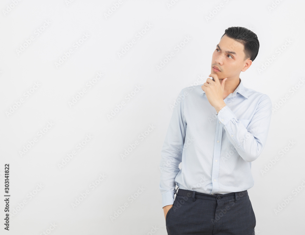 Young handsome asian business man thinking an idea while looking up isolated on white background. Young handsome asian business man thinking an idea while looking up isolated on white background.