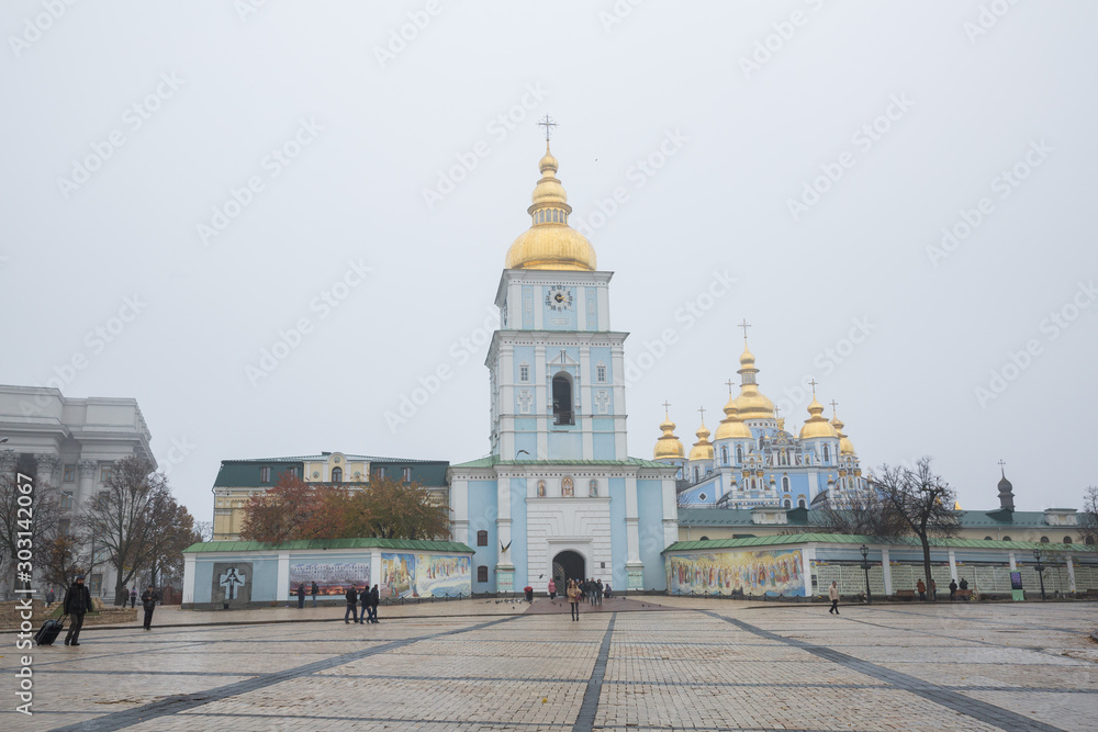 City Kiev, Ukrainian. Morning mist and church in the city center. Passers-by and tourists walk down the street.