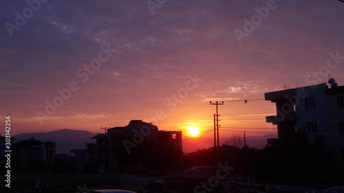 A sunrise scenery captured with buildings as silhouettes around.