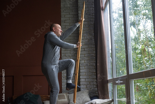 a man in pajamas pretends to be climbing stairs photo