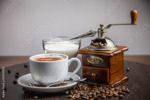 coffee on a tray with a coffee grinder and sugar