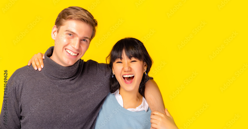 Portrait adorable romantic fellow bonding best friend, soulmate or lovely young couple. enjoying each other placing arms around neck together. happiness, laughing together copy space yellow background Portrait adorable romantic fellow bonding best friend, soulmate or lovely young couple. enjoying each other placing arms around neck together. happiness, laughing together copy space yellow background