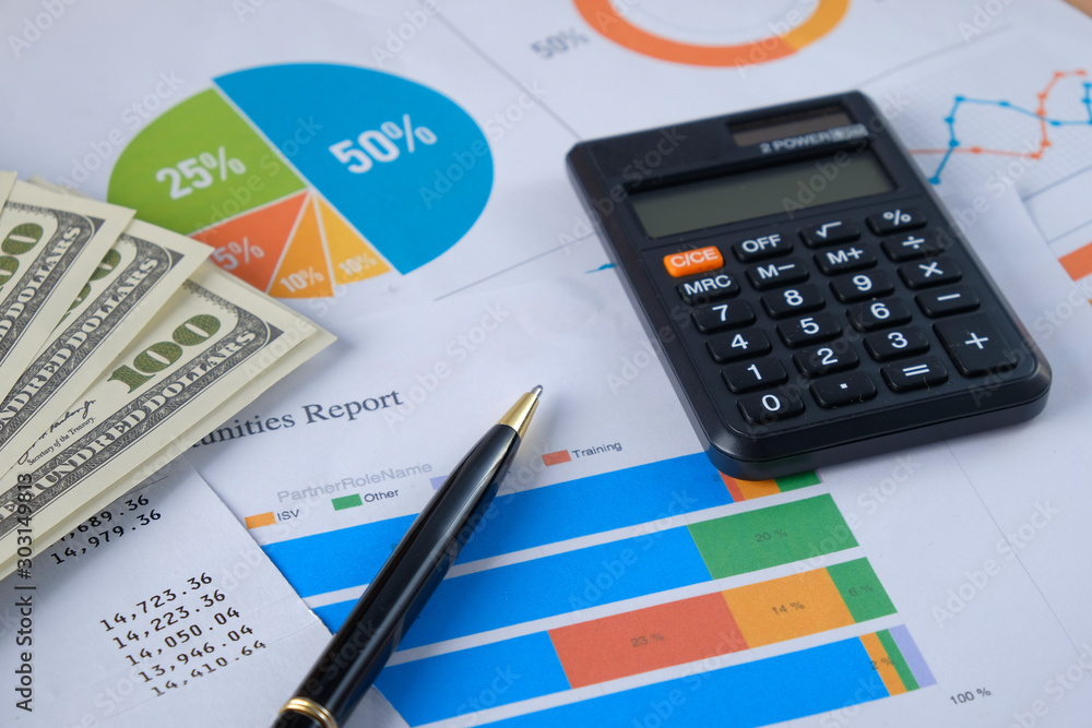 Financial reports on the table, business attributes, pen and calculator with banknotes in the wallet. Business growth concept background for business and money Financial reports on the table, business attributes, pen and calculator with banknotes in the wallet. Business growth concept background for business and money